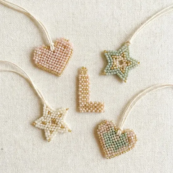 Beaded hearts, stars and a letter tag on cotton cord